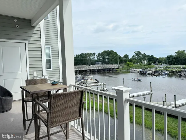 a view of a chairs and table on wooden deck