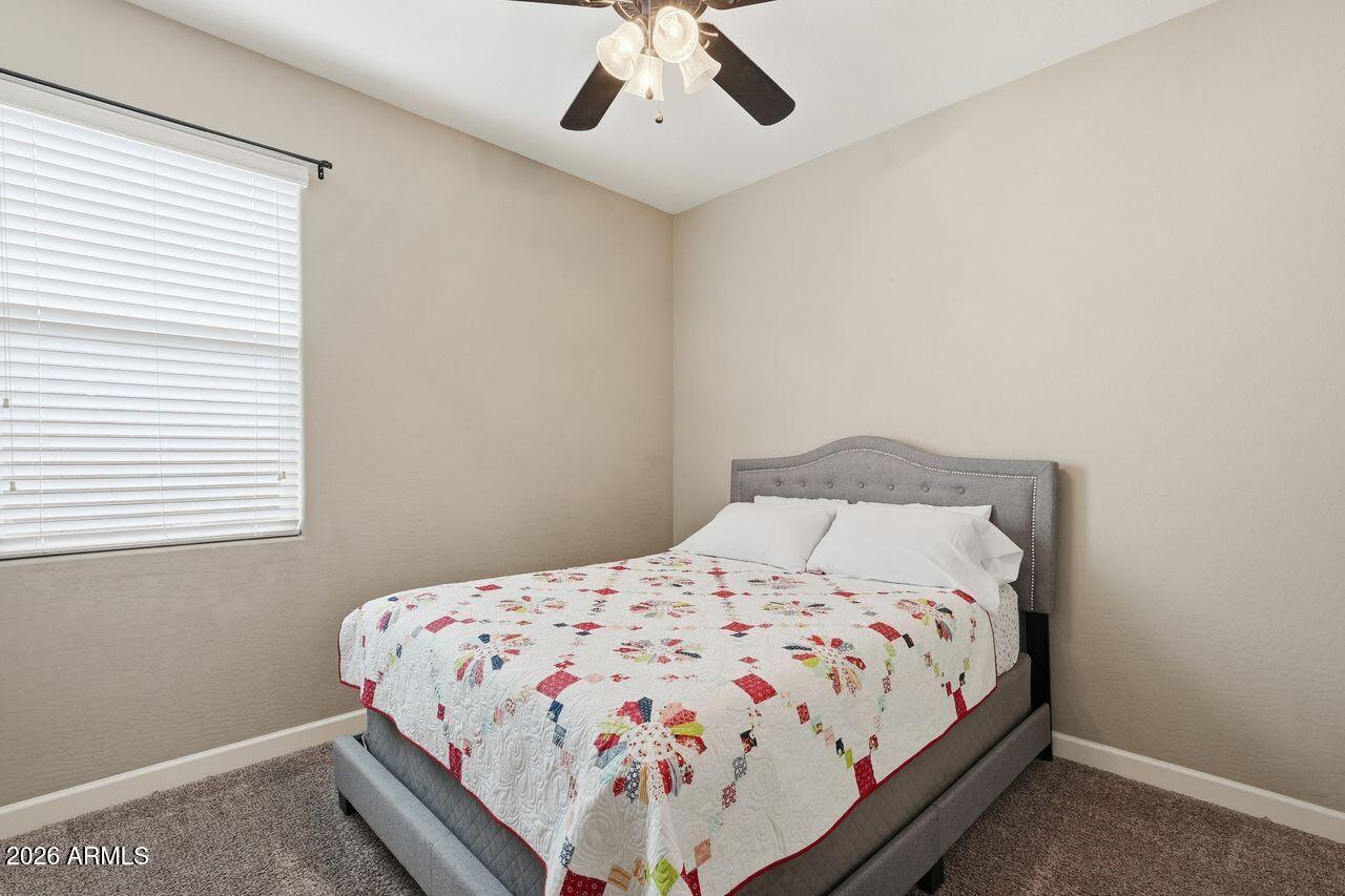 23602 West Ripple Road Buckeye, AZ 85326 - Photo 32 of 38 a bedroom with a bed and a window
