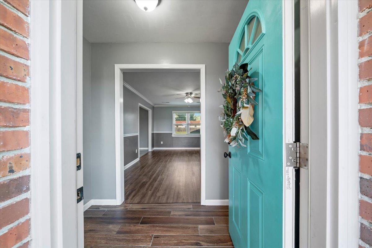 9496 Holly Grove Road Brighton, TN 38011 - Photo 4 of 29 Entryway featuring dark wood-style floors, ceiling fan, and ornamental molding