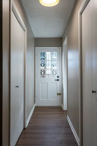 a view of a hallway with wooden floor