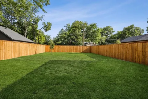a bedroom with a large bed and a potted plant