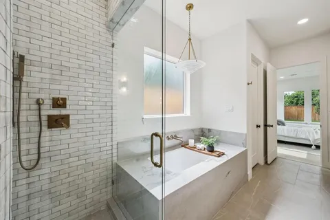 a spacious bathroom with a granite countertop sink mirror and a shower