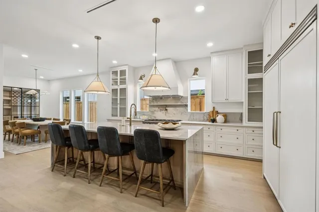 a kitchen with granite countertop a sink cabinets and stainless steel appliances