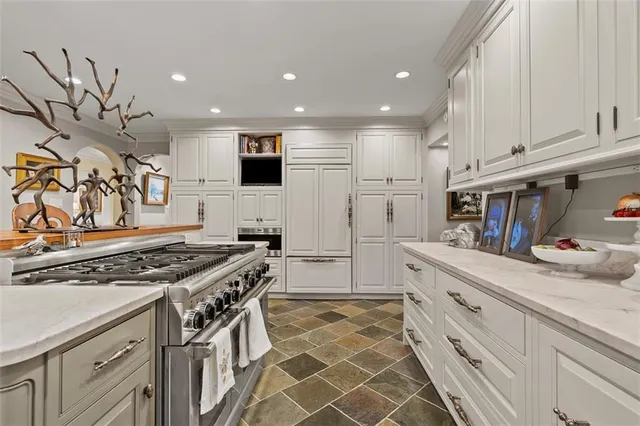 a kitchen with stainless steel appliances granite countertop a stove and a sink