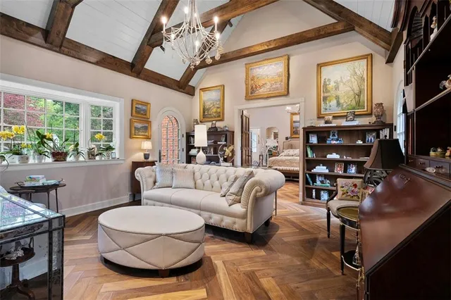 a living room with furniture a flat screen tv and a large window