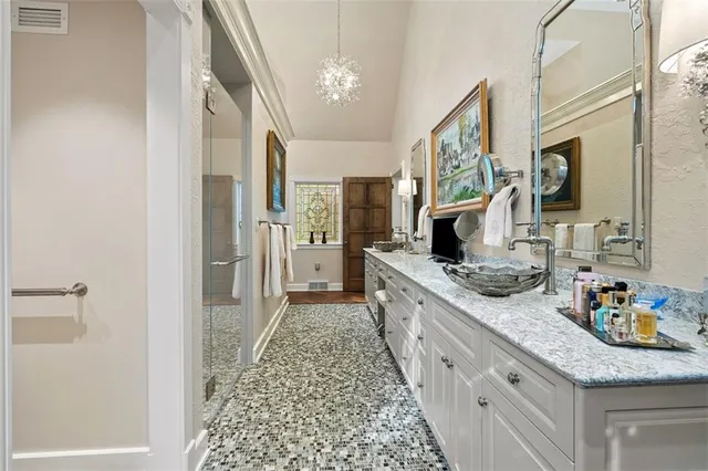 a large kitchen with a double vanity sink and a refrigerator