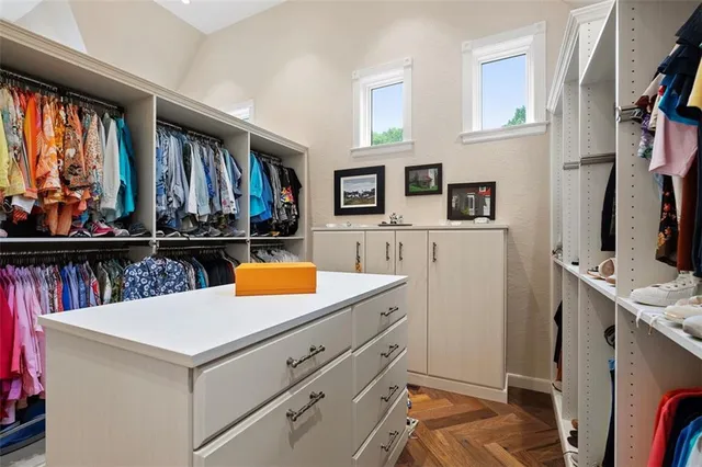 a view of walk in closet with clothes and shoes