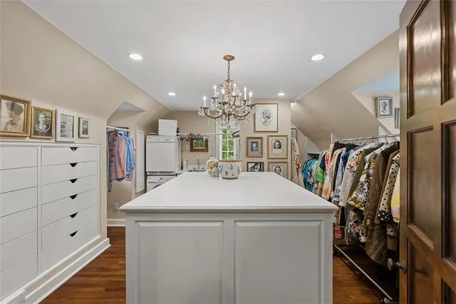 a view of a livingroom with a fireplace a chandelier and wooden floor