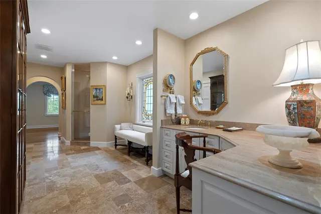 a spacious bedroom with a bed and a view of bathroom