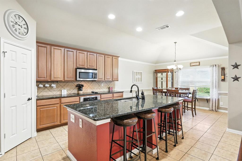 a kitchen with granite countertop a sink and cabinets