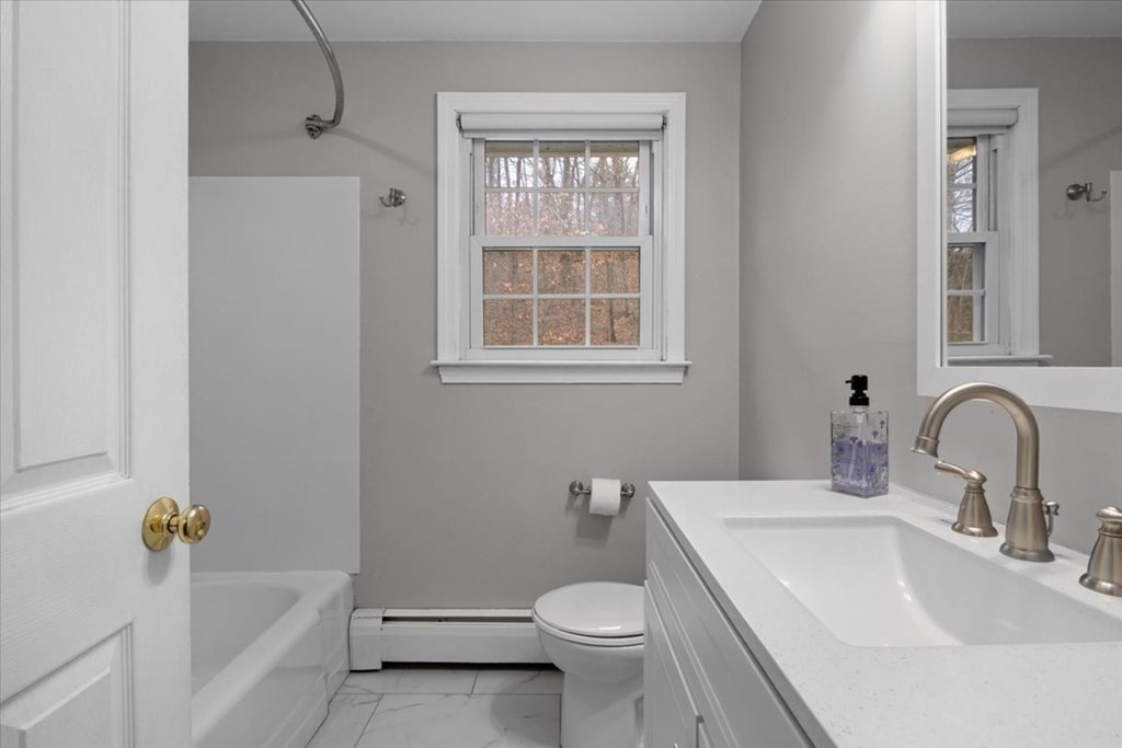 124 Turtle Pond Parkway Boston, MA 02136 - Photo 12 of 39 a bathroom with a sink toilet and shower