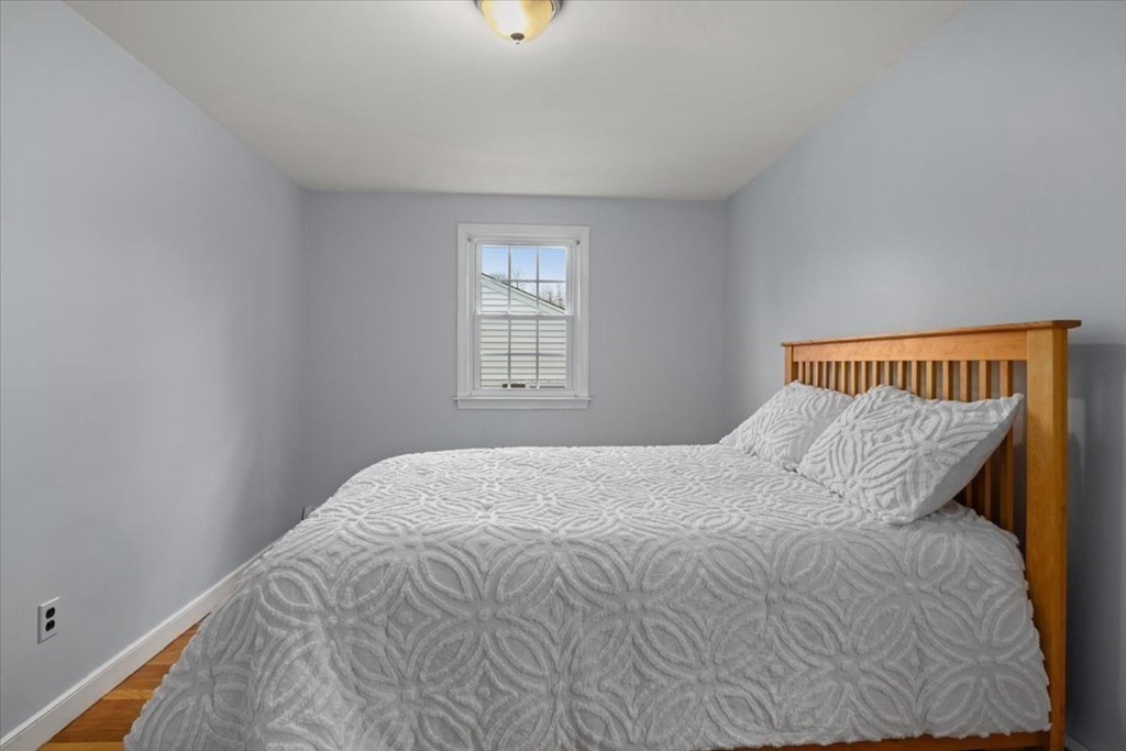 124 Turtle Pond Parkway Boston, MA 02136 - Photo 18 of 39 a bedroom with a bed and window