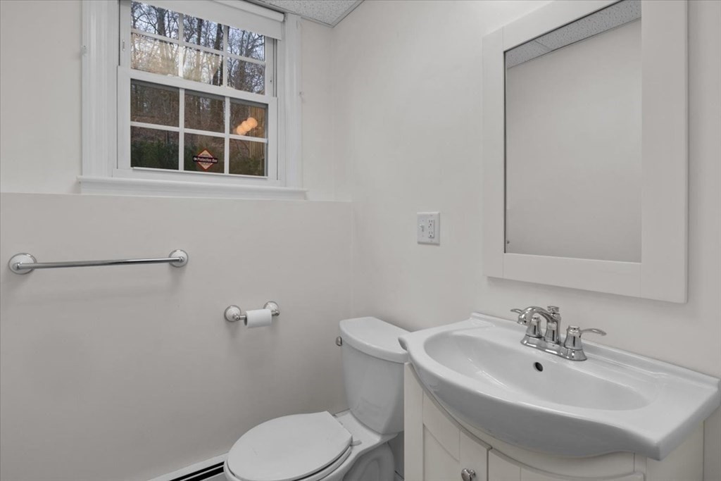 124 Turtle Pond Parkway Boston, MA 02136 - Photo 27 of 39 a bathroom with a sink a toilet and a mirror
