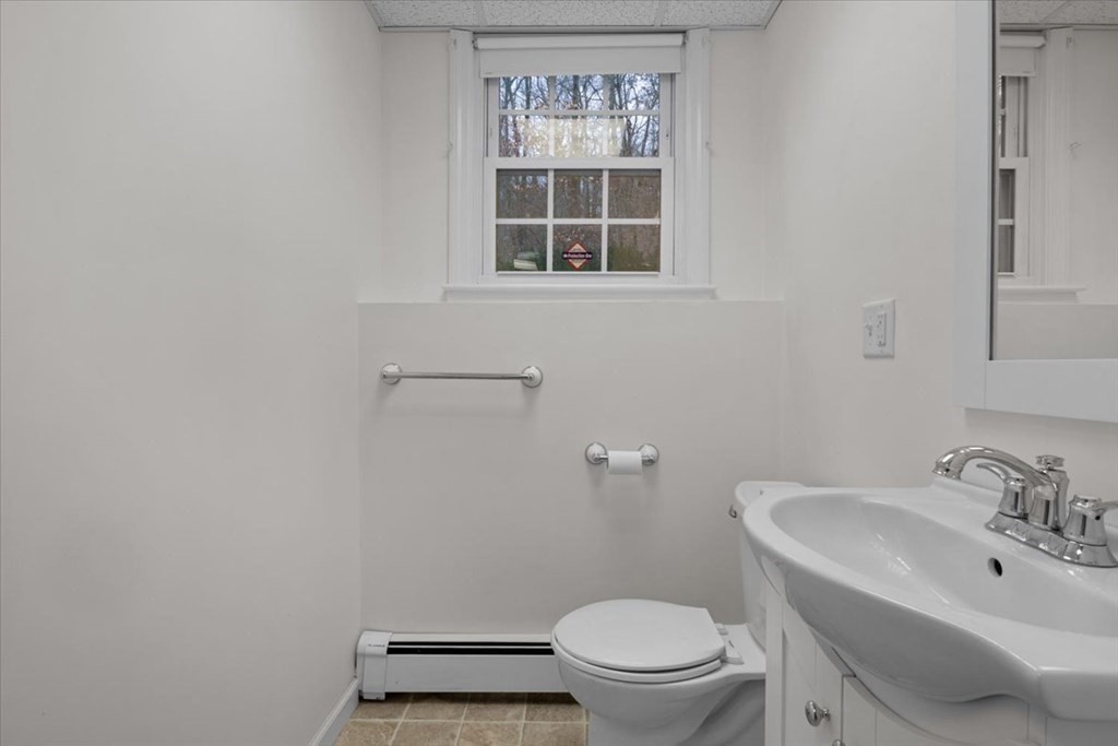 124 Turtle Pond Parkway Boston, MA 02136 - Photo 28 of 39 a bathroom with a sink toilet and a mirror