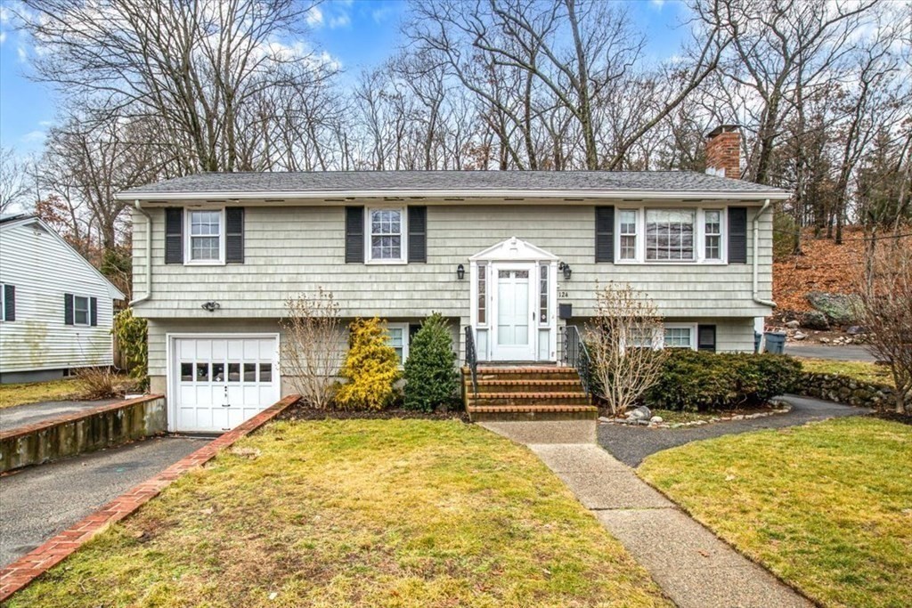124 Turtle Pond Parkway Boston, MA 02136 - Photo 37 of 39 a front view of a house with a yard garage and outdoor seating