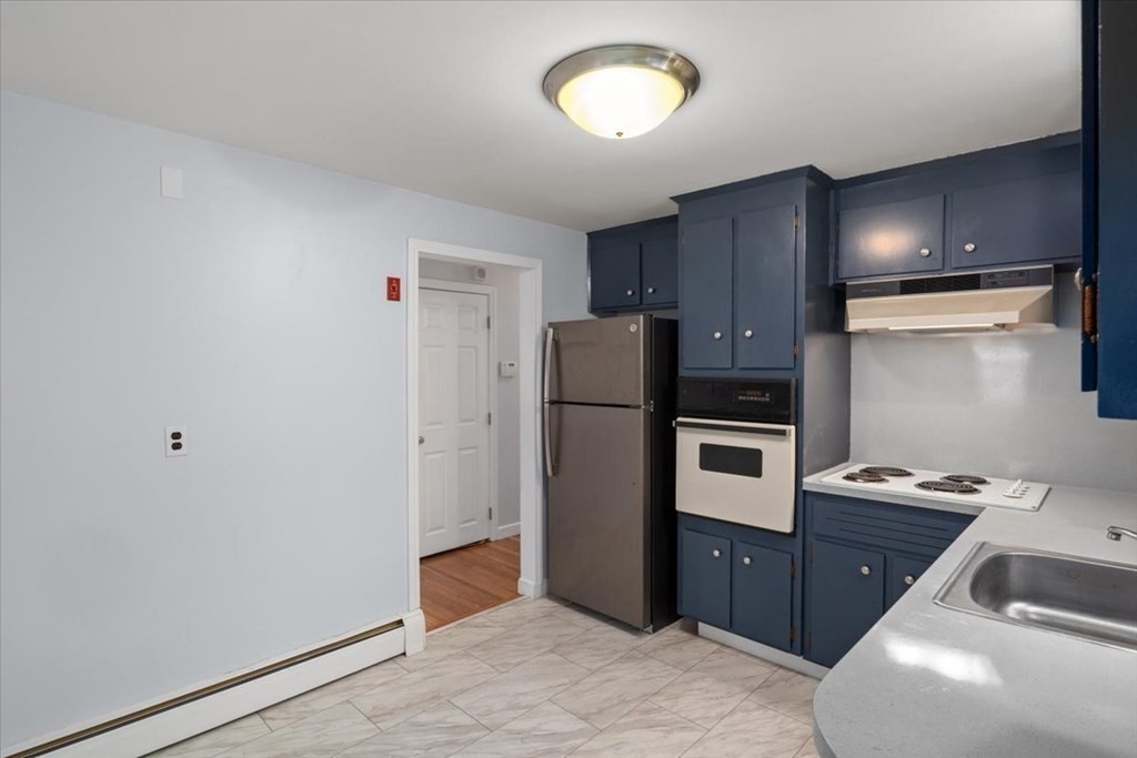 124 Turtle Pond Parkway Boston, MA 02136 - Photo 9 of 39 a kitchen with a refrigerator and a sink