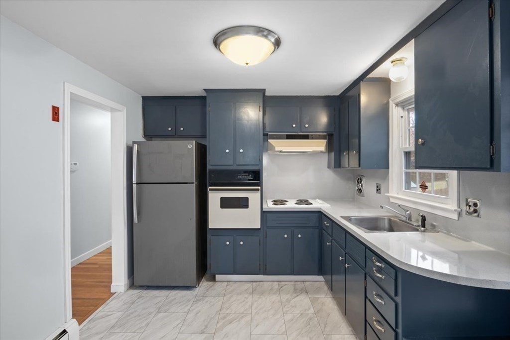 124 Turtle Pond Parkway Boston, MA 02136 - Photo 10 of 39 a kitchen with a sink refrigerator and cabinets