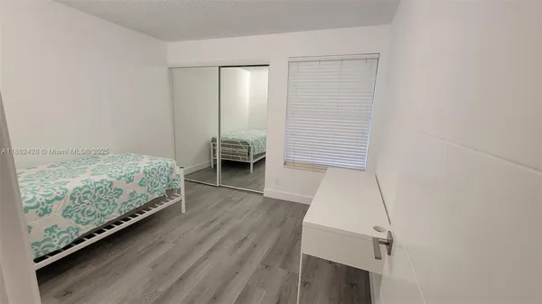 a view of room with furniture and wooden floor