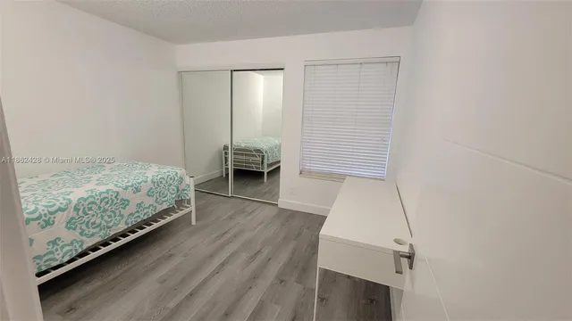 a view of room with furniture and wooden floor