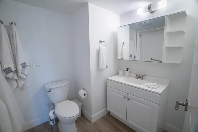 a white toilet sitting next to a bath tub