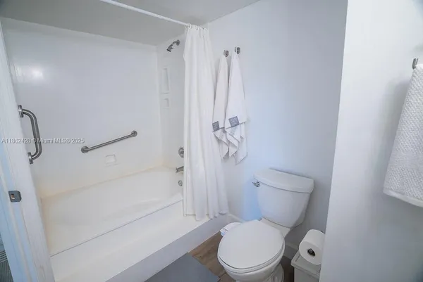 a view of a livingroom with furniture window and wooden floor