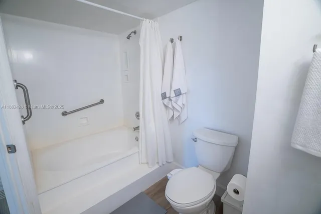 a view of a livingroom with furniture window and wooden floor