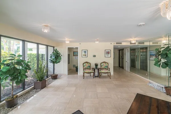 a view of a hallway with wooden floor and a table in it