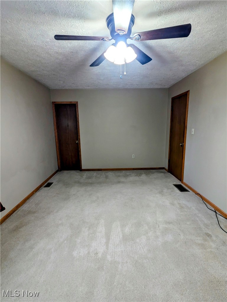 62769 Riggs Road Bellaire, OH 43906 - Photo 18 of 20 Carpeted empty room featuring ceiling fan and a textured ceiling