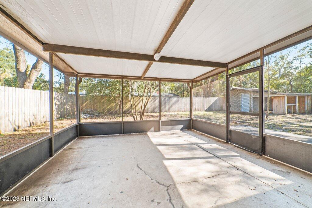 6147 Temple Road Jacksonville, FL 32217 - Photo 29 of 36 a view of an empty room with wooden floor and a floor to ceiling window
