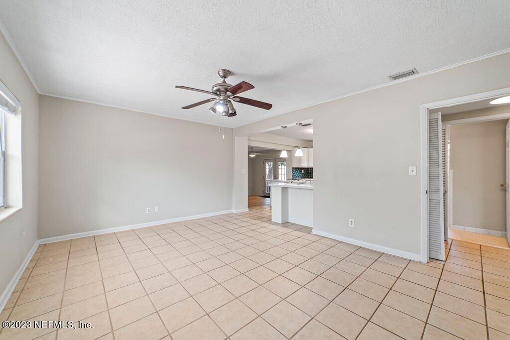6147 Temple Road Jacksonville, FL 32217 - Photo 6 of 36 a view of a livingroom with a chandelier fan and windows