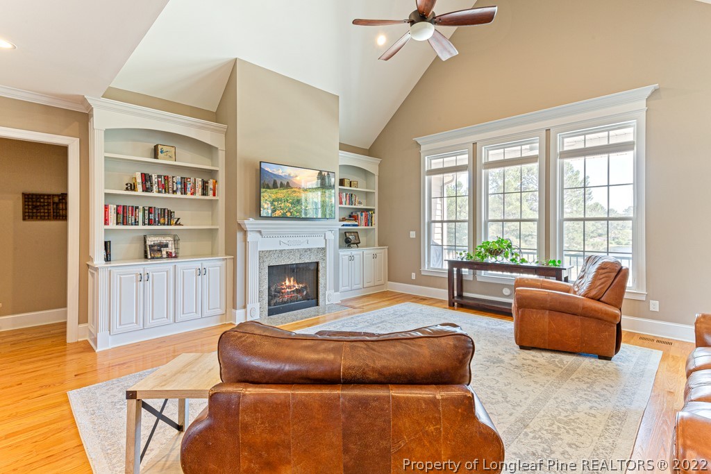 375 East Lake Ridge Road Raeford, NC 28376 - Photo 12 of 50 a living room with furniture a fireplace and a large window