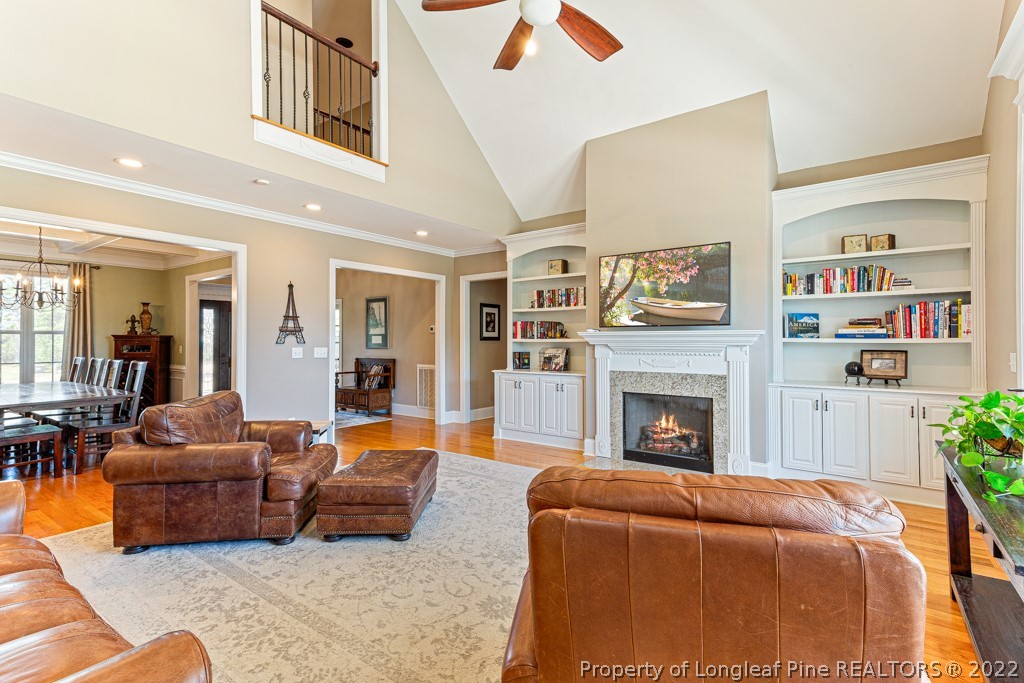 375 East Lake Ridge Road Raeford, NC 28376 - Photo 13 of 50 a living room with furniture and a fireplace