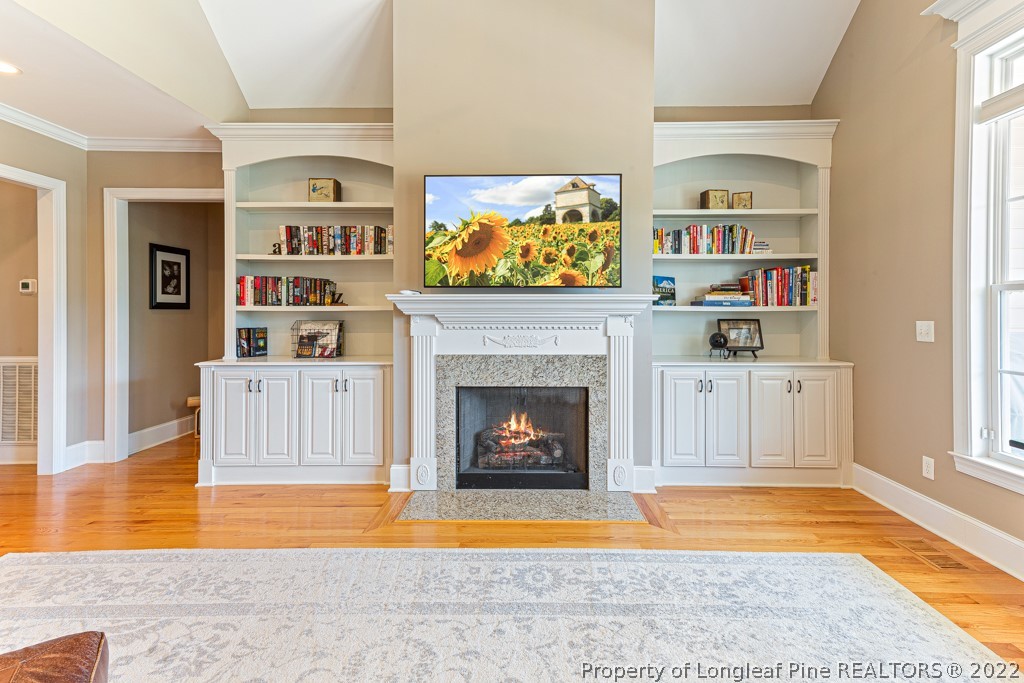 375 East Lake Ridge Road Raeford, NC 28376 - Photo 14 of 50 a living room with furniture a fireplace and a flat screen tv