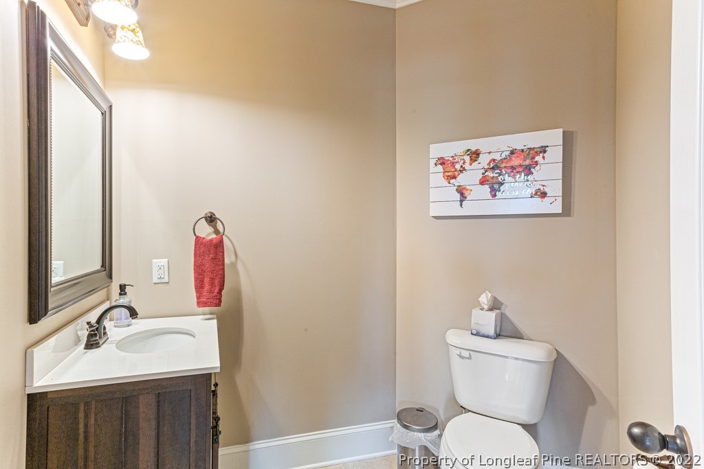 375 East Lake Ridge Road Raeford, NC 28376 - Photo 18 of 50 a bathroom with a toilet sink and mirror
