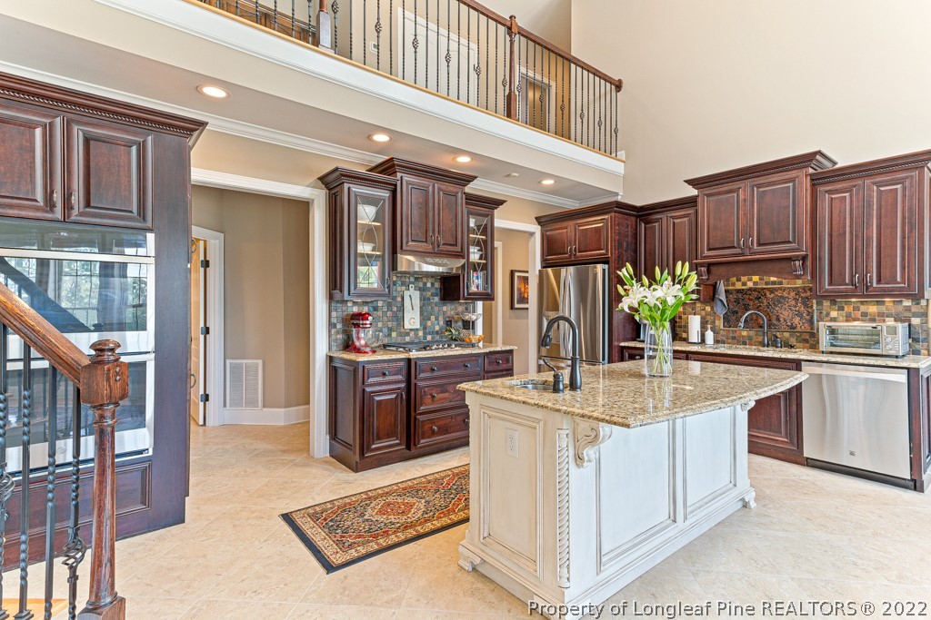 375 East Lake Ridge Road Raeford, NC 28376 - Photo 20 of 50 a kitchen with kitchen island granite countertop a stove and cabinets