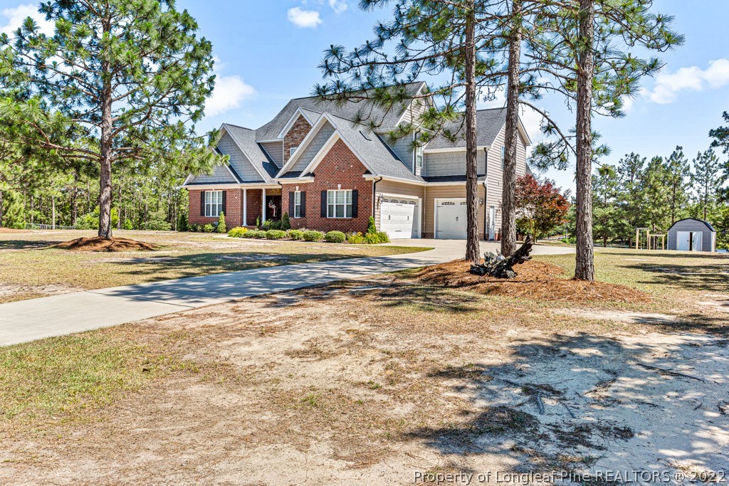375 East Lake Ridge Road Raeford, NC 28376 - Photo 2 of 50 a front view of a house with a yard and trees