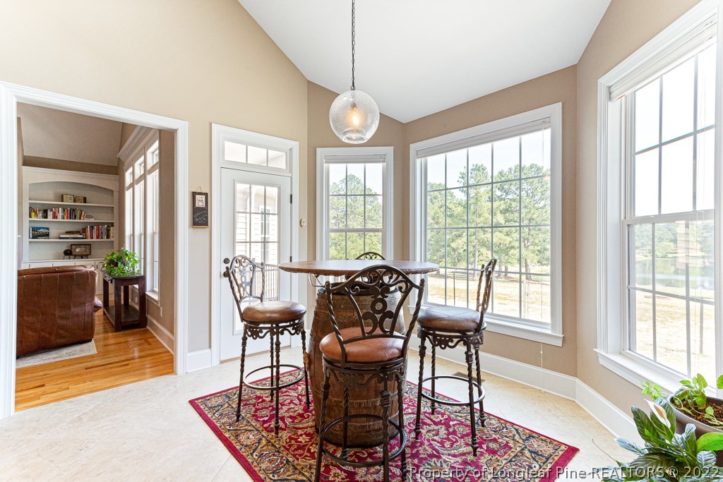 375 East Lake Ridge Road Raeford, NC 28376 - Photo 21 of 50 a dining room with furniture wooden floor and a rug