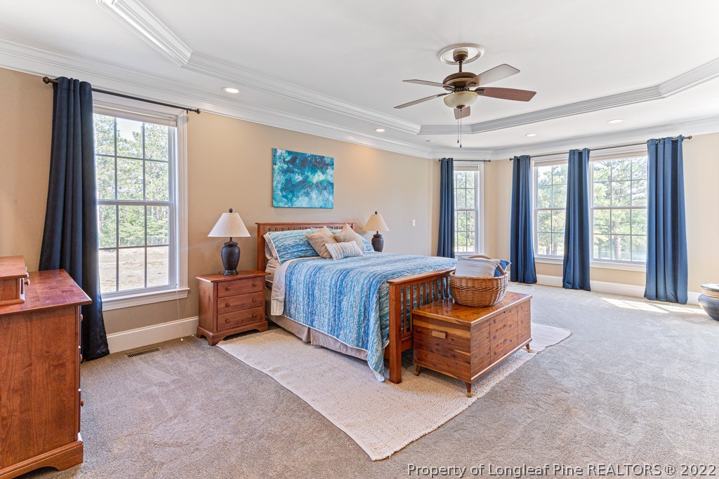 375 East Lake Ridge Road Raeford, NC 28376 - Photo 27 of 50 a bedroom with a bed and a couch next to a window