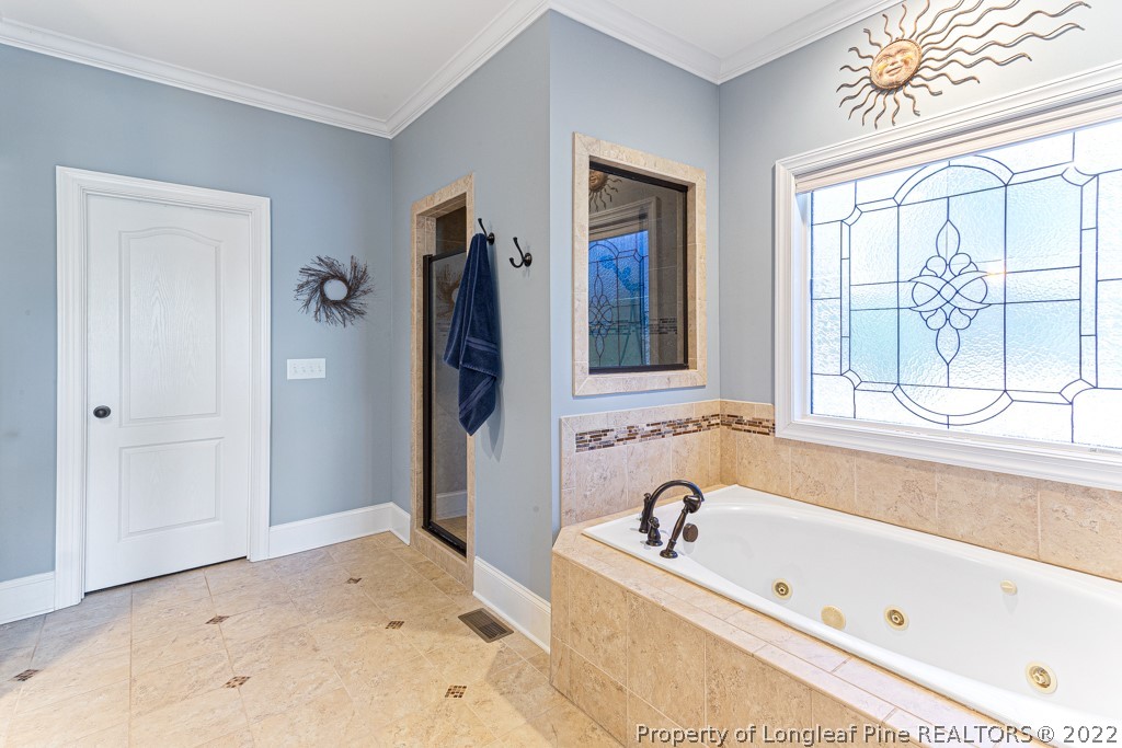 375 East Lake Ridge Road Raeford, NC 28376 - Photo 28 of 50 a bathroom with a tub and a window