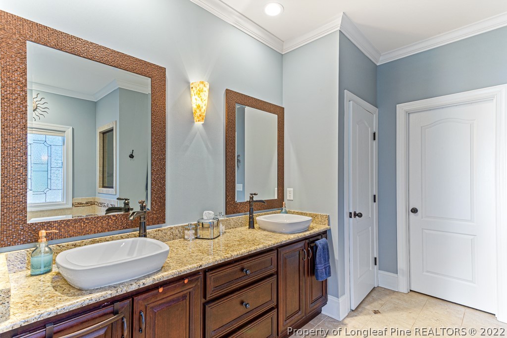 375 East Lake Ridge Road Raeford, NC 28376 - Photo 29 of 50 a bathroom with double vanity sinks and a mirror