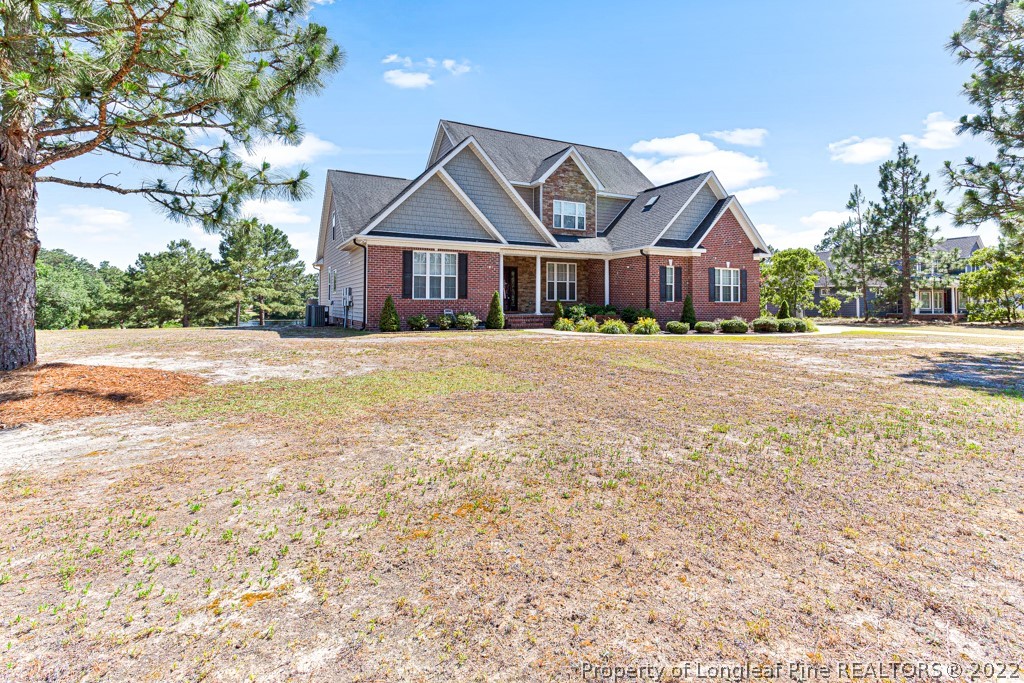 375 East Lake Ridge Road Raeford, NC 28376 - Photo 3 of 50 a front view of a house with a garden