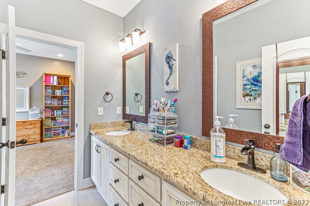 375 East Lake Ridge Road Raeford, NC 28376 - Photo 36 of 50 a bathroom with a granite countertop double vanity sink and a mirror