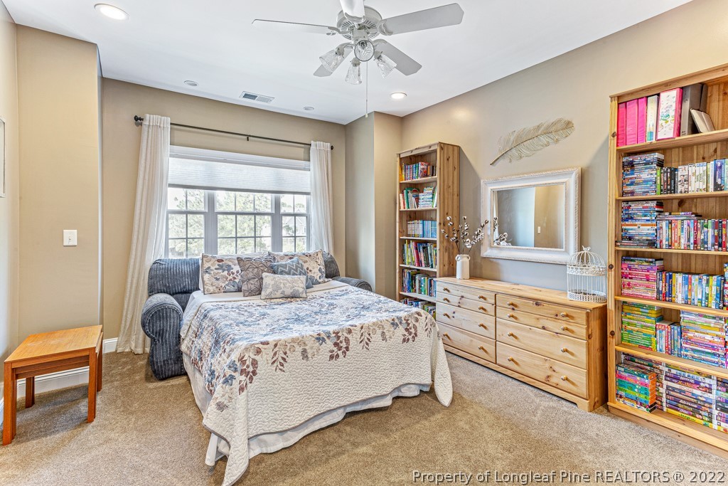 375 East Lake Ridge Road Raeford, NC 28376 - Photo 37 of 50 a bedroom with a bed cabinets and furniture