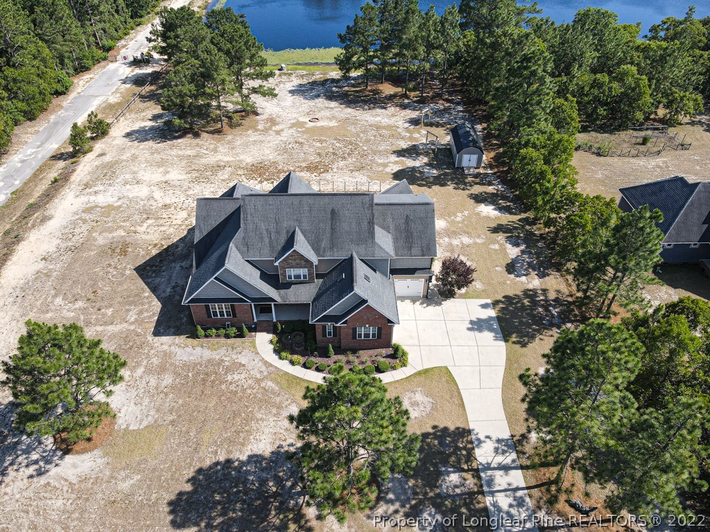 375 East Lake Ridge Road Raeford, NC 28376 - Photo 47 of 50 an aerial view of a house with a yard and wooden fence
