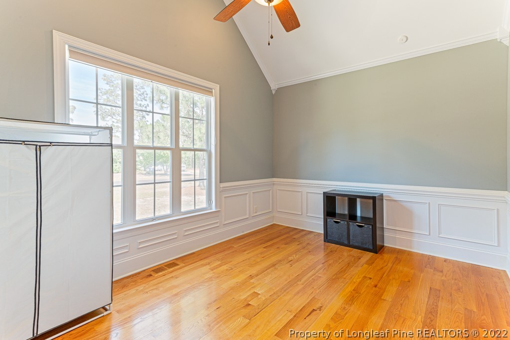 375 East Lake Ridge Road Raeford, NC 28376 - Photo 8 of 50 a view of empty room with wooden floor and fan