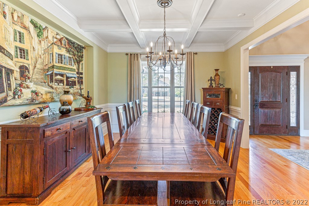 375 East Lake Ridge Road Raeford, NC 28376 - Photo 10 of 50 a view of a dining room with furniture a chandelier and wooden floor