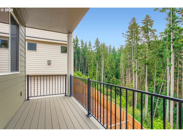 a view of balcony with wooden floor and fence