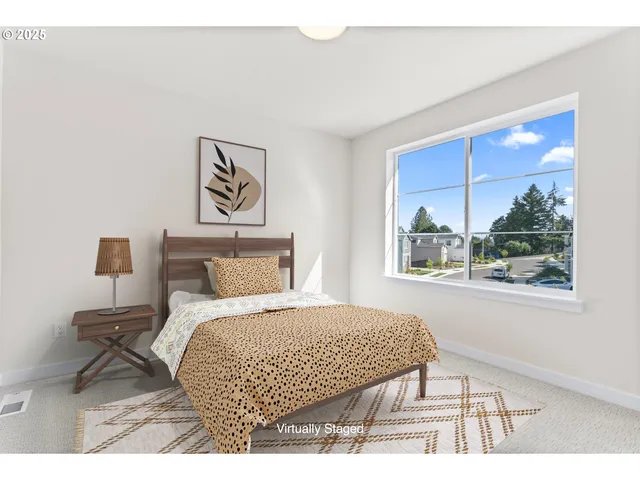 a bedroom with a bed and a painting on the wall