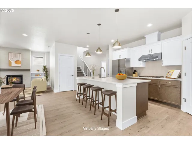 a kitchen with a table chairs sink and cabinets