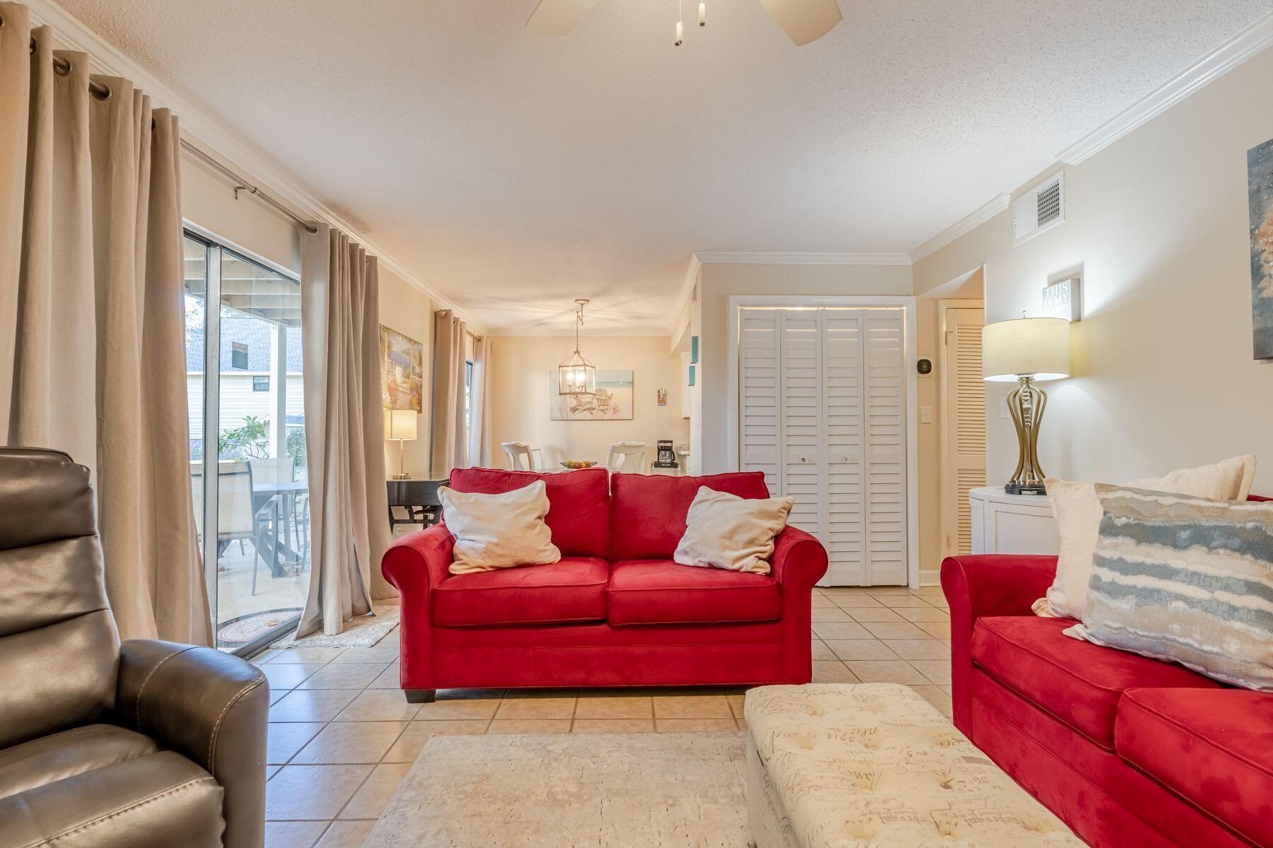 56 Sunset Bay, Unit 17B Miramar Beach, FL 32550 - Photo 11 of 30 a living room with furniture and a large window